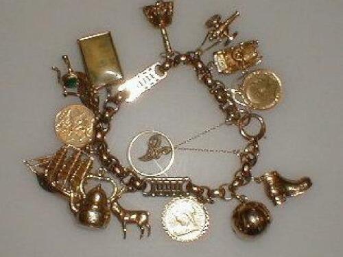 A heavy belcher charm bracelet with fourteen charms attached including