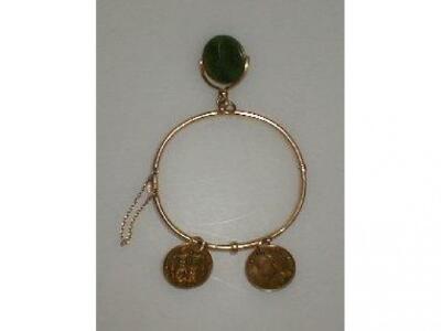 A Victorian plain hinged bangle marked 15 with jade shamrock engraved swivel