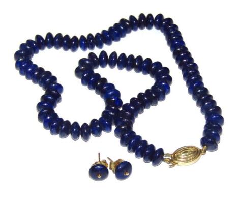 A lapis lazuli necklace with stud earrings