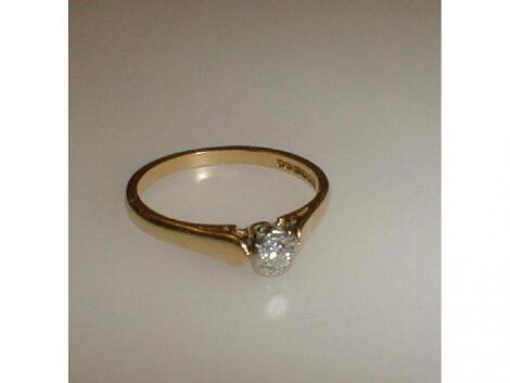 A small diamond solitaire in 18ct gold