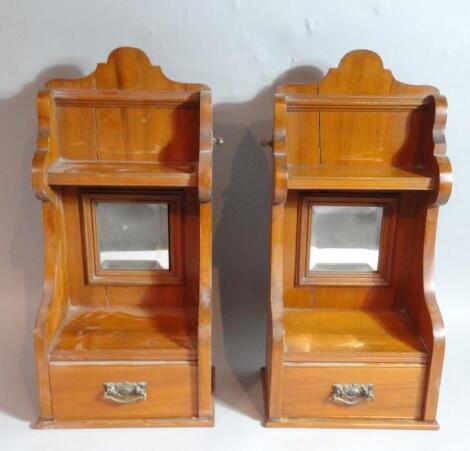 A matched pair of late Edwardian satin walnut wall cabinets