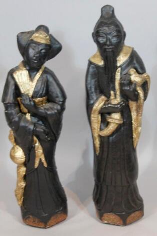 A pair of reproduction carved oriental figures