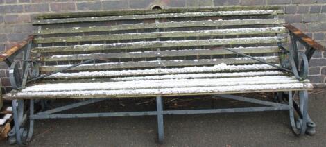 A cast iron and wooden slatted four seater bench