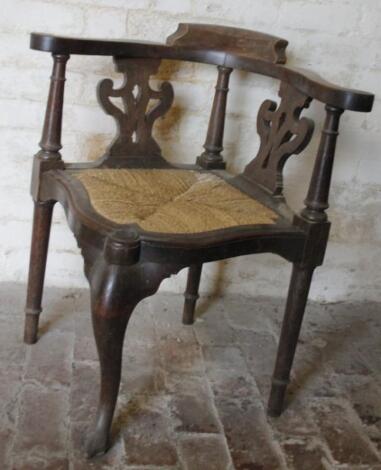 An early 19thC oak and elm corner chair