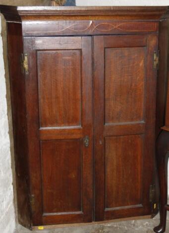 An 18thC oak mahogany and inlaid hanging corner cupboard