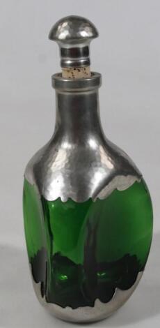 A Royal Holland green glass and hammered pewter decanter