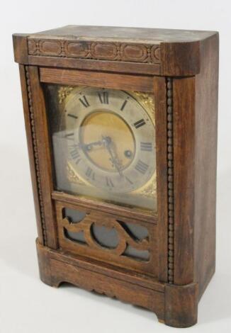 An early 20th century oak cased mantel clock