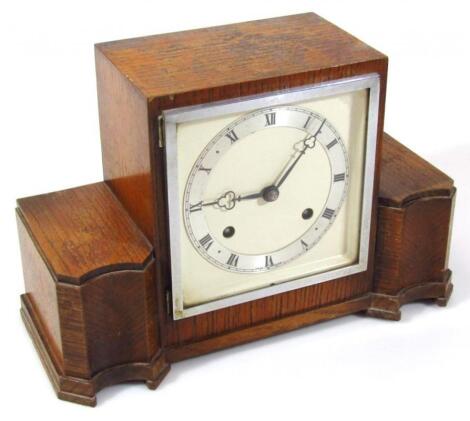 A mid 20thC oak cased mantel clock