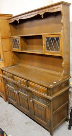 An Ercol style linen fold dresser