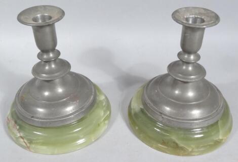 A pair of pewter dwarf candlesticks