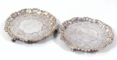 A pair of George II silver waiters