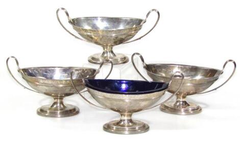 A set of four George III silver footed bowls