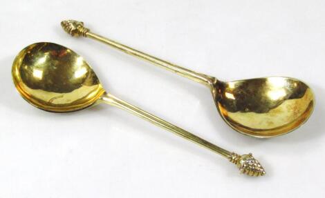 A pair of import silver gilt graduated marriage spoons