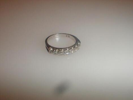 A diamond set half hoop eternity ring set with seven small diamonds