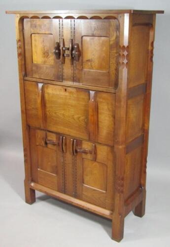 An early 20thC Cotswold Gimson style Arts and Crafts oak and walnut side cabinet