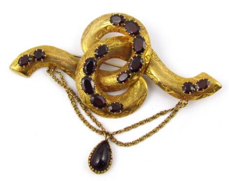 A Victorian bloomed gold brooch set with faceted garnets with a cabochon garnet drop