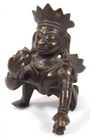 An Indian bronze figure of Krishna with butter pot