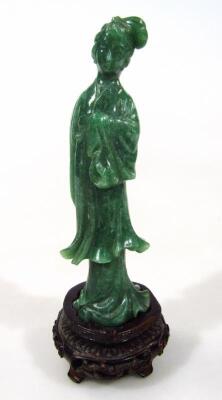 A dark green jade coloured figure of a geisha