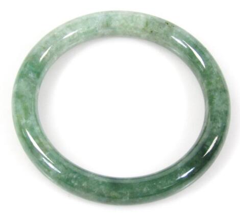 A 20thC Peking green glass jade coloured bangle