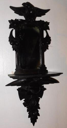 A 19thC Continental ebonised and carved mirrored wall shelf