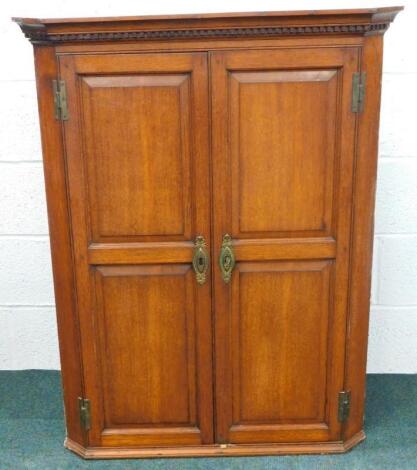 A George III oak hanging corner cabinet