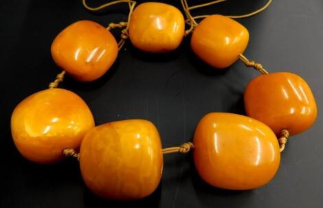 A seven bead butterscotch coloured amber necklace