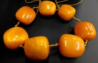 A seven bead butterscotch coloured amber necklace