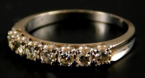 A diamond half hoop eternity ring