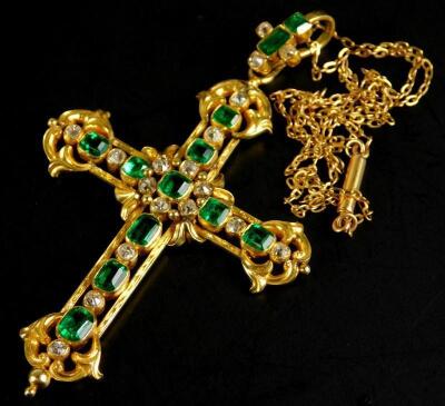 An ornate emerald and diamond set crucifix