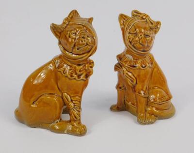 A late 19thC grotesque pottery cat and dog pair