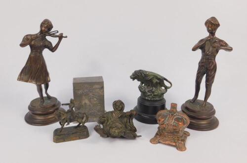 A pair of cast metal figures modelled as musicians