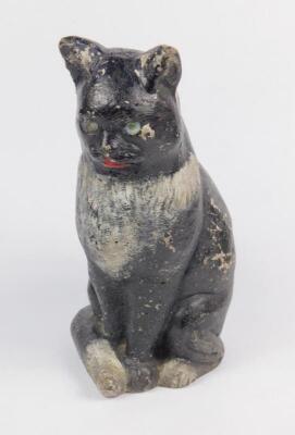 A plaster early 20thC figural door stop modelled as a seated cat