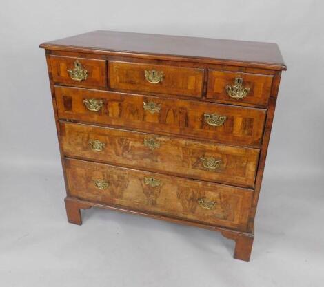 A George II walnut and cross banded chest of drawers