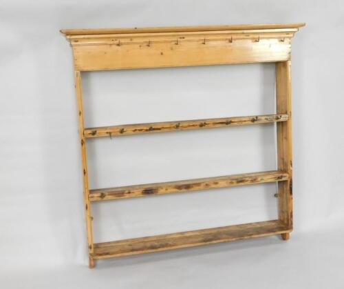 An antique graduated pine hanging plate rack