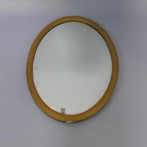 A gilt framed oval wall mirror