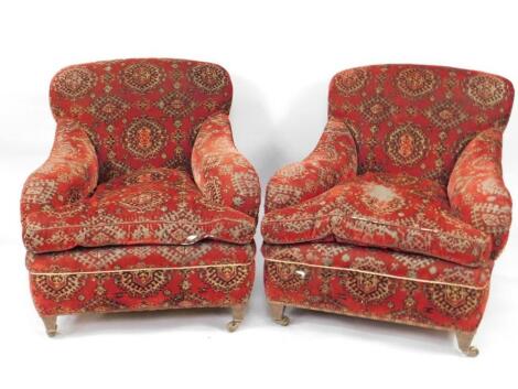 A pair of Victorian low seated easy chairs