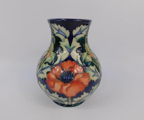 A Moorcroft pottery baluster vase decorated in the Poppy pattern