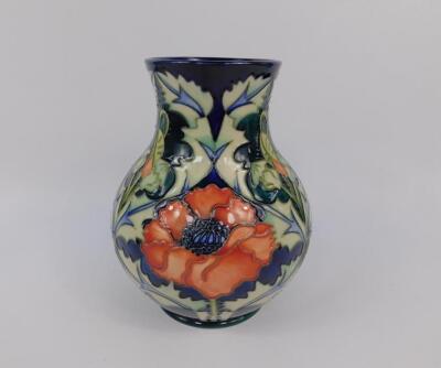 A Moorcroft pottery baluster vase decorated in the Poppy pattern