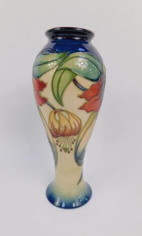 A Moorcroft pottery baluster vase decorated in the Anna Lily pattern