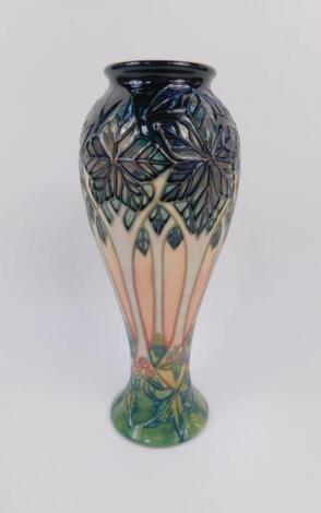 A Moorcroft pottery baluster vase decorated in the Cluny pattern