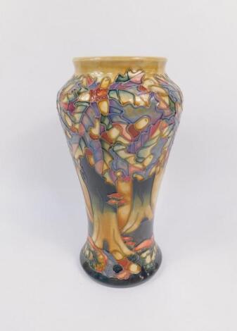 A Moorcroft pottery baluster vase decorated in the Knightwood pattern