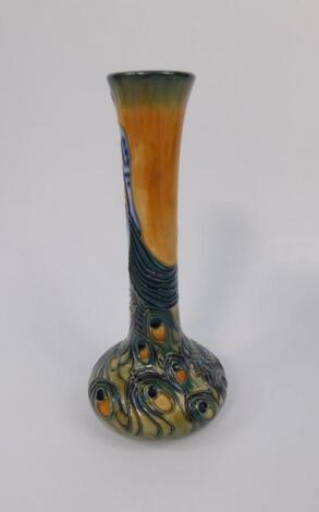 A Moorcroft pottery slender necked vase decorated in the Phoenix Bird pattern