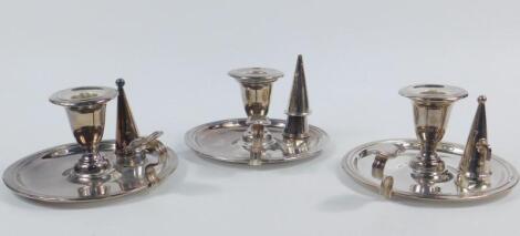 A set of three matched late 19thC silver plated taper sticks