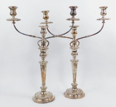 A pair of early 20thC silver plated three branch candelabra