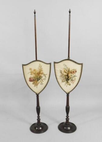 A pair of late 19th/early 20thC mahogany pole screens