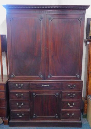 A George III mahogany clothes press in the manner of Thomas Chippendale