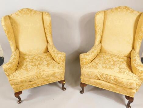 A set of four George III style wingback armchairs