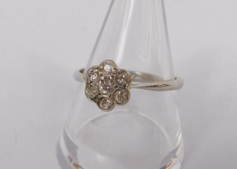 A diamond seven stone flower head ring