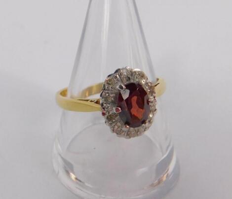 An 18ct gold red stone and diamond set ring