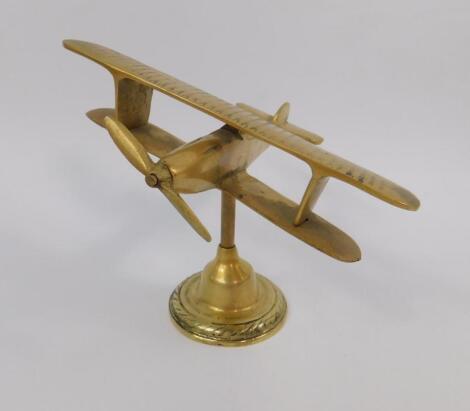 A brass paperweight modelled as a Tiger Moth bi-plane